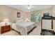 Bright bedroom featuring neutral walls, a window, and a treadmill for convenient exercise at 404 Carryback Dr, Marietta, GA 30068