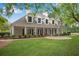 Exterior view of the clubhouse with well manicured lawn and landscaping with large columns at 404 Carryback Dr, Marietta, GA 30068