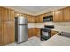 Bright kitchen with stainless steel appliances and wood cabinetry at 404 Carryback Dr, Marietta, GA 30068