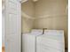 Laundry room featuring white appliances, wire shelving, and a neutral wall color at 404 Carryback Dr, Marietta, GA 30068