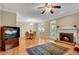 Open-concept living room with a fireplace, hardwood floors, and a dining area at 404 Carryback Dr, Marietta, GA 30068