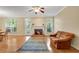 Living room with hardwood floors, a fireplace, and natural light from large windows at 404 Carryback Dr, Marietta, GA 30068