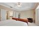 Bright main bedroom featuring a tray ceiling, neutral decor, and an en suite bathroom at 404 Carryback Dr, Marietta, GA 30068