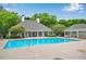 Sparkling community pool with shaded seating area with clubhouse in the background at 404 Carryback Dr, Marietta, GA 30068