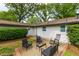Charming backyard patio with outdoor seating, surrounded by lush greenery and the home's exterior at 4147 Suzanne Ln, Duluth, GA 30096