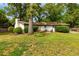 Spacious backyard view featuring a patio, lush trees, and the home's white-painted exterior at 4147 Suzanne Ln, Duluth, GA 30096