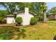 Spacious backyard featuring a white brick exterior, lush greenery, and a cozy patio area for outdoor enjoyment at 4147 Suzanne Ln, Duluth, GA 30096