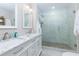 Elegant bathroom featuring a marble vanity with double sinks and a glass-enclosed shower with stone flooring at 4147 Suzanne Ln, Duluth, GA 30096