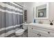 Neutral bathroom with a shower-tub combo, vanity, and ample lighting at 4147 Suzanne Ln, Duluth, GA 30096