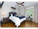 Bedroom featuring hardwood floors, a ceiling fan, and a large window at 4147 Suzanne Ln, Duluth, GA 30096