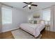 Cozy bedroom with ceiling fan, neutral walls, and a decorative rug accentuating the hardwood floors at 4147 Suzanne Ln, Duluth, GA 30096