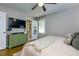 Bedroom features hardwood floors, a green dresser, and a TV, with a bathroom visible through an open door at 4147 Suzanne Ln, Duluth, GA 30096