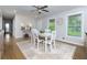 Dining room featuring a ceiling fan, a modern rug and two large windows at 4147 Suzanne Ln, Duluth, GA 30096