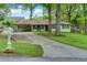 Charming single-story home with a well-maintained lawn, mature trees, and a mailbox at 4147 Suzanne Ln, Duluth, GA 30096