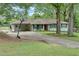 Charming single-story home with a well-maintained lawn, mature trees, and a basketball hoop at 4147 Suzanne Ln, Duluth, GA 30096