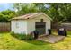 Detached garage with gray door, complemented by potted plants and surrounded by green grass at 4147 Suzanne Ln, Duluth, GA 30096