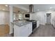 Open kitchen features granite countertops, stainless steel appliances, and a view into the living room at 4147 Suzanne Ln, Duluth, GA 30096