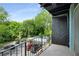 Balcony view of a community pool, with parking and mature trees at 120 Alden Nw Ave # C3, Atlanta, GA 30309
