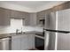 Updated kitchen with stainless steel appliances, granite countertops, and gray cabinetry at 120 Alden Nw Ave # C3, Atlanta, GA 30309