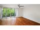 Open living room with sliding doors to balcony, hardwood floors, ceiling fan, and plenty of light at 120 Alden Nw Ave # C3, Atlanta, GA 30309