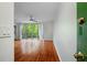 Entry into the home with hardwood floors with a view to living room with sliding glass doors to balcony and trees at 120 Alden Nw Ave # C3, Atlanta, GA 30309