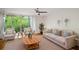 Bright living room features a ceiling fan, hardwood floors, and sliding glass doors to a balcony with a scenic view at 120 Alden Nw Ave # C3, Atlanta, GA 30309