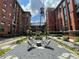 An exterior courtyard featuring lounge seating surrounded by historic brick buildings at 170 Boulevard Se # H301, Atlanta, GA 30312