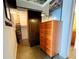 A dresser with a lamp and art, located beside the door to the closet and an adjacent bathroom entrance at 170 Boulevard Se # H301, Atlanta, GA 30312