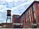Exterior view of an old brick industrial building with a vintage water tower in the foreground at 170 Boulevard Se # H301, Atlanta, GA 30312