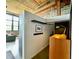 Hallway view showcasing a desk, mounted coat rack, and a vintage brick wall detail in a stylish interior at 170 Boulevard Se # H301, Atlanta, GA 30312