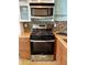 Galley kitchen featuring stainless steel appliances, a gas range, and tiled backsplash at 170 Boulevard Se # H301, Atlanta, GA 30312