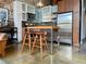 Modern kitchen features stainless steel appliances, butcher block island, and stylish bar stools at 170 Boulevard Se # H301, Atlanta, GA 30312