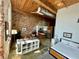 Bright, open living space combining kitchen, living, and bedroom areas with exposed brick and wood ceilings at 170 Boulevard Se # H301, Atlanta, GA 30312