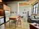 Open living area with kitchen island, stainless appliances, and exposed brick at 170 Boulevard Se # H301, Atlanta, GA 30312