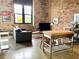 Bright living area with brick walls, tall windows, and an open floor plan at 170 Boulevard Se # H301, Atlanta, GA 30312