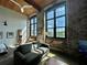 Bright living room with exposed brick, wood ceilings, and large windows offering ample natural light at 170 Boulevard Se # H301, Atlanta, GA 30312