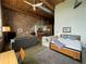 Open concept living room with high ceilings, exposed brick walls and modern furnishings and updated kitchen at 170 Boulevard Se # H301, Atlanta, GA 30312