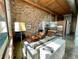 Open-concept living space with exposed brick and wood ceilings blends living, dining, and kitchen areas at 170 Boulevard Se # H301, Atlanta, GA 30312