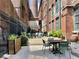 Comfortable outdoor seating area with a table and chairs surrounded by lush greenery and exposed brick walls at 170 Boulevard Se # H301, Atlanta, GA 30312