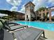 Community pool featuring comfortable chaise lounges and umbrellas on a sunny day at 170 Boulevard Se # H301, Atlanta, GA 30312