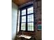Window with a view and plenty of natural light set in a brick wall above a desk with workspace at 170 Boulevard Se # H301, Atlanta, GA 30312