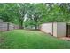 Expansive backyard with lush greenery, wooden fence, and metal building at 200 Rogers Rd, Kingston, GA 30145