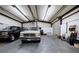 Large garage interior featuring concrete floors and two trucks parked on the premises at 200 Rogers Rd, Kingston, GA 30145