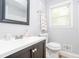 Bathroom with a vanity sink, a large framed mirror, and a window with natural light at 2462 Pate S St, Snellville, GA 30078