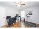 Bedroom with hardwood floors, two windows, and exercise equipment and desk area at 2462 Pate S St, Snellville, GA 30078