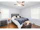 Comfortable bedroom featuring wood floors, natural light, and a ceiling fan at 2462 Pate S St, Snellville, GA 30078