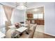 Elegant dining room with a glass table, modern chairs, and open view to kitchen at 2462 Pate S St, Snellville, GA 30078