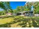 Well-manicured lawn surrounds this lovely single-story home, complemented by mature trees and ample sunlight at 2462 Pate S St, Snellville, GA 30078