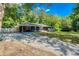 Charming single-story home with a well-maintained lawn, gravel driveway, and inviting front porch at 2462 Pate S St, Snellville, GA 30078