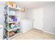 Functional laundry area with washer, dryer, and shelving for storage and organization at 2462 Pate S St, Snellville, GA 30078